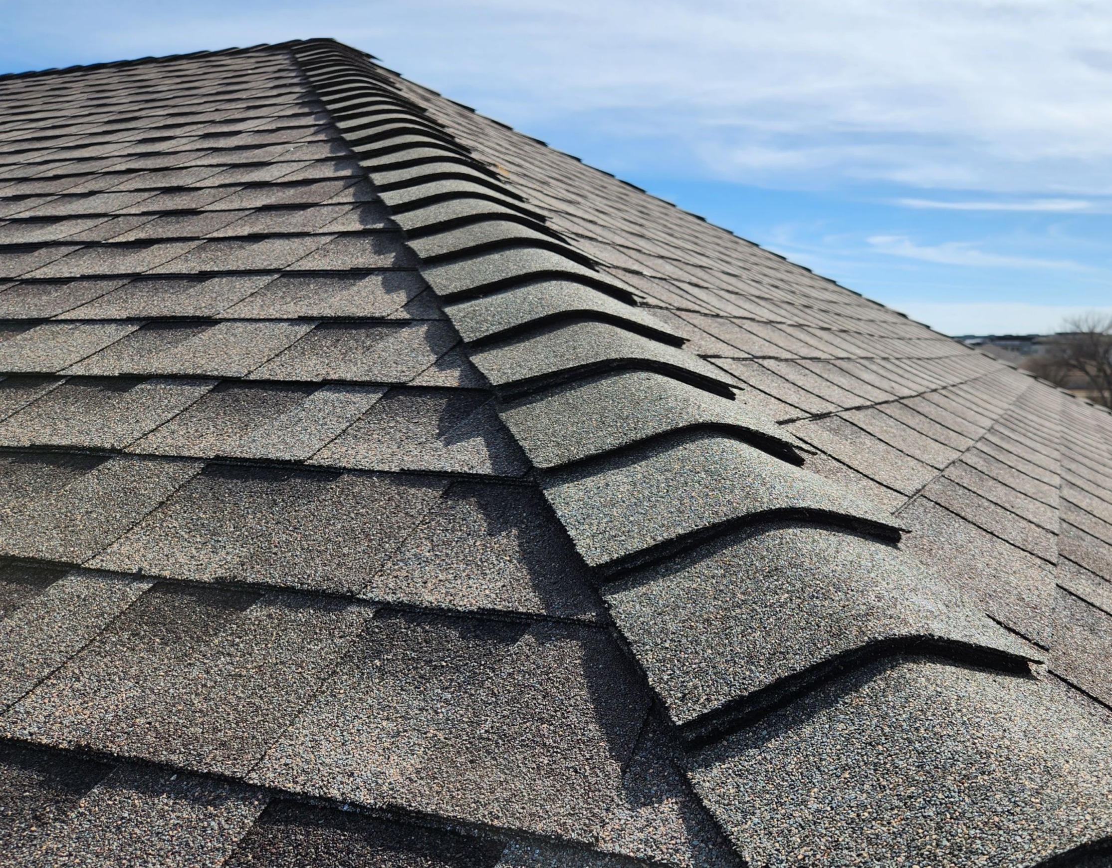 Close-up of newly installed roof ridge cap shingles