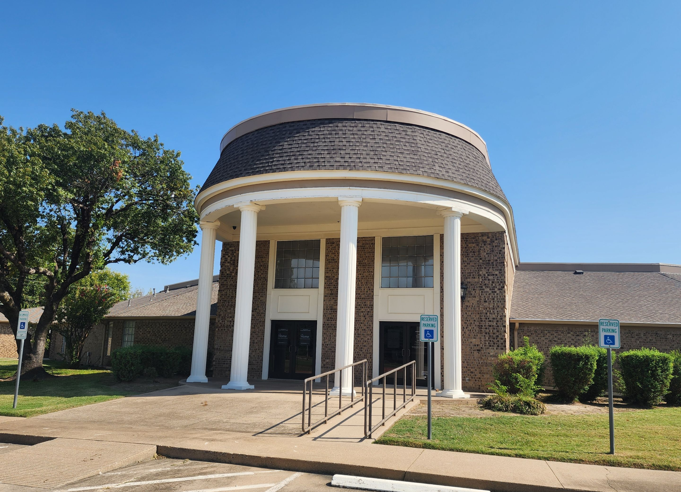 Commercial building with circular shingled roof